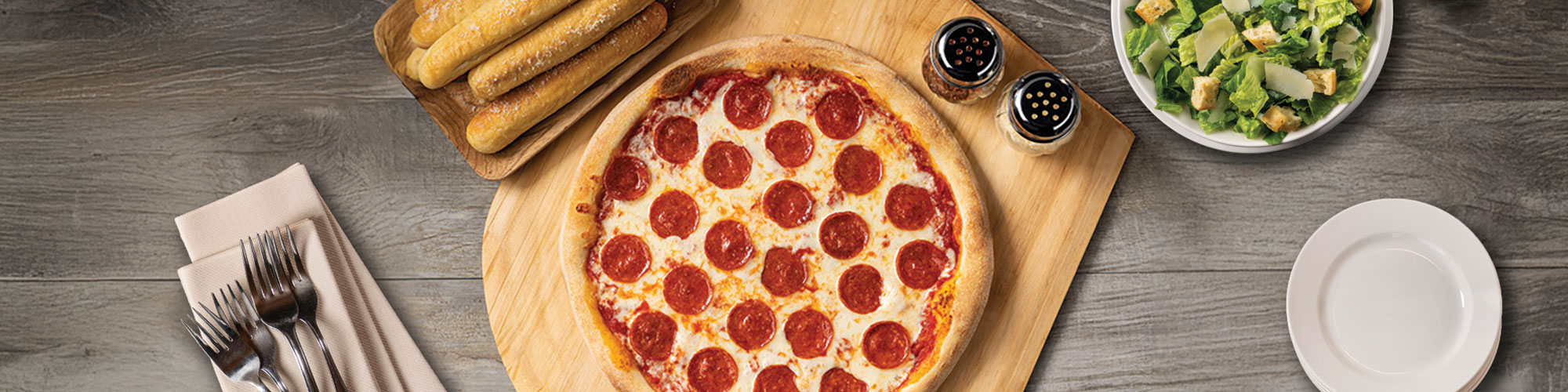 Pizza, bread sticks, and salad